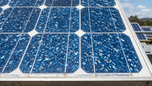 Close-up of blue polycrystalline commercial solar panel cells showing speckled multi-crystal pattern