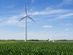 Wind turbine on open farmland showing suitable land conditions for agricultural wind energy