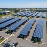 commercial solar carports installed over parking lot generating clean electricity for business property
