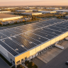Commercial rooftop solar panel installation on a large warehouse facility showing the scale of a typical business solar system