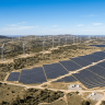 Wind turbines and solar panels generating clean energy in an open landscape