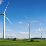 Large wind turbines in a green landscape showing wind energy generation